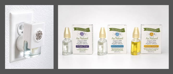 White, decorative plug-in diffuser in wall outlet next to refill bottles and packaging